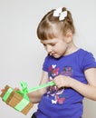 Happy little girl opening gift box Royalty Free Stock Photo