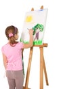 Happy little girl painting on easel Royalty Free Stock Photo