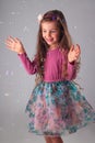 Happy little girl in party dress playing with soap bubbles portrait Royalty Free Stock Photo