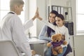 Happy little girl patient gives five smiling male pediatrician after medical examination. Royalty Free Stock Photo