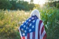 Happy little girl patriot running in the field with American flag Royalty Free Stock Photo