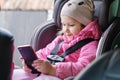 Happy little girl with phone in car Royalty Free Stock Photo