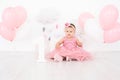 happy little girl in pink dress celebrating her first birthday with balloons Royalty Free Stock Photo