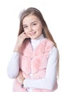 Happy little girl in pink fur vest posing Royalty Free Stock Photo