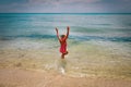 Happy little girl play on beach, child splash water and enjoy vacation Royalty Free Stock Photo