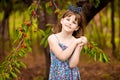 Happy little girl play near cherry tree in summer garden. Kid picking cherry on fruit farm. Child pick cherries in summer orchard.