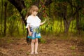 Happy little girl play near cherry tree in summer garden. Kid picking cherry on fruit farm. Child pick cherries in orchard. Royalty Free Stock Photo