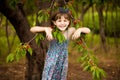 Happy little girl play near cherry tree in summer garden. Kid picking cherry on fruit farm. Child pick cherries in orchard.