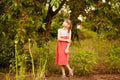 Happy little girl play near cherry tree in summer garden. Kid picking cherry on fruit farm. Child pick cherries in orchard. Royalty Free Stock Photo