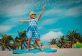 Happy little girl play with surf board on beach, child enjoy vacation Royalty Free Stock Photo