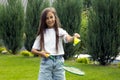 Happy little girl playing badminton in the park. Royalty Free Stock Photo