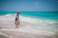 Kid at the ocean. Happy little girl playing on the beach. Holiday, outdoors.