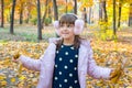 Happy little girl is playing in a beautiful autumn park on a sunny day. Games on the nature Royalty Free Stock Photo