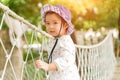 Happy little girl playing climbing on the rope bridge Royalty Free Stock Photo