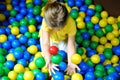 Happy little girl playing at colorful plastic balls playground Royalty Free Stock Photo