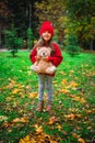Happy little girl playing with his teddy bear toy in autumnal park Royalty Free Stock Photo