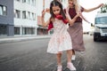 A happy little girl playing hopscotch with her mother on a playground outside. A child plays with her mom. Kid plays with mum Royalty Free Stock Photo