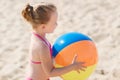 Happy little girl playing inflatable ball on beach Royalty Free Stock Photo