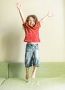 Happy little girl playing and jumping at home Royalty Free Stock Photo