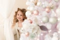 Happy little girl playing near the Christmas tree. Royalty Free Stock Photo