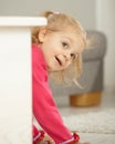 Happy little girl playing peek-a-boo Royalty Free Stock Photo