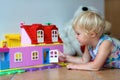 Happy little girl playing with plastic blocks Royalty Free Stock Photo