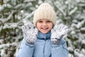 Happy little girl playing with snow in beautiful winter forest. Walking and active rest in winter Royalty Free Stock Photo