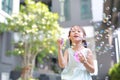 Happy little girl playing soap bubbles in garden Royalty Free Stock Photo
