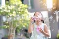 Happy little girl playing soap bubbles in garden Royalty Free Stock Photo