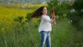 Happy little girl playing among soap bubbles on green meadow in summer Royalty Free Stock Photo