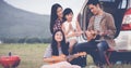 Happy little girl playing ukulele with asian family sitting in t Royalty Free Stock Photo