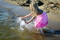 Happy little girl playing with water on the beach Royalty Free Stock Photo