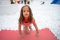 Happy little girl playing white plastic balls pool in amusement park Royalty Free Stock Photo