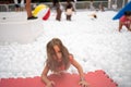 Happy little girl playing white plastic balls pool in amusement park Royalty Free Stock Photo