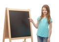 Happy little girl pointing finger to blackboard Royalty Free Stock Photo