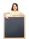 Happy little girl pointing finger to blackboard Royalty Free Stock Photo