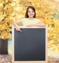 Happy little girl pointing finger to blackboard Royalty Free Stock Photo