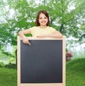 Happy little girl pointing finger to blackboard Royalty Free Stock Photo