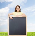 Happy little girl pointing finger to blackboard Royalty Free Stock Photo