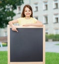 Happy little girl pointing finger to blackboard Royalty Free Stock Photo