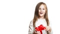 Happy little girl preschooler holding a box with a gift and red bow. concept of giving and receiving gifts. on white background. Royalty Free Stock Photo