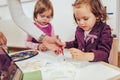 Happy little girl, preschooler, painting with water color Royalty Free Stock Photo
