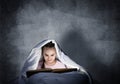 Happy little girl reading book in bed Royalty Free Stock Photo