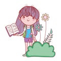 Happy little girl reading book in the garden Royalty Free Stock Photo