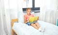 Happy little girl reading book at home Royalty Free Stock Photo