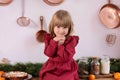 Happy little girl in red dress on Christmas eve at home. Sincere child emotions. Smile child enjoying New year gift. Happy little