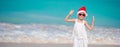 Adorable little girl in Santa hat on tropical beach Royalty Free Stock Photo