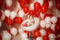 Happy little girl with red and white balloons Royalty Free Stock Photo