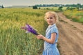 Happy little girl in a retro dress on a summer walk in the countryside . Royalty Free Stock Photo