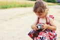 Happy little girl in retro outfit taking pictures with old film Royalty Free Stock Photo